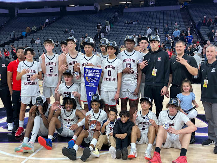 Modesto Christian celebrates then poses after 68-63 win over Lincoln for the Sac-Joaquin Section D1 championship at Golden 1 Center.